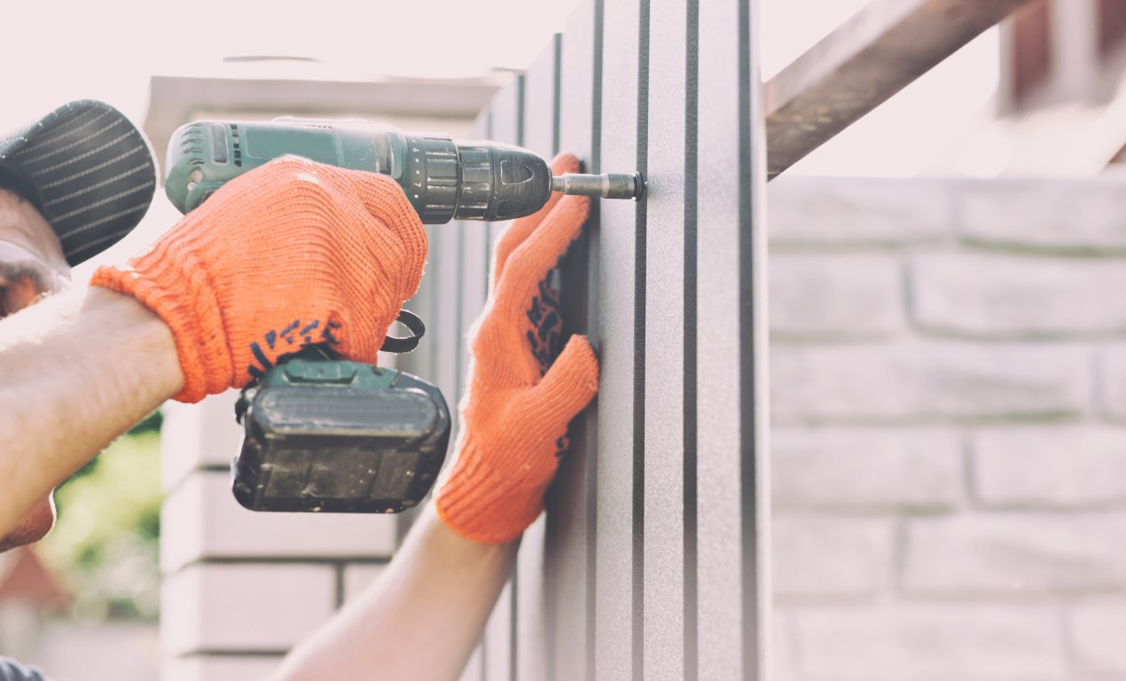 An image of a person working on a fence installation service