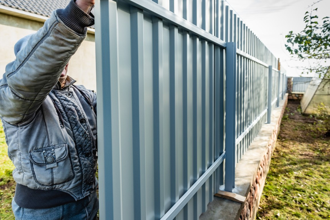 A picture of a person working on a fence installation service