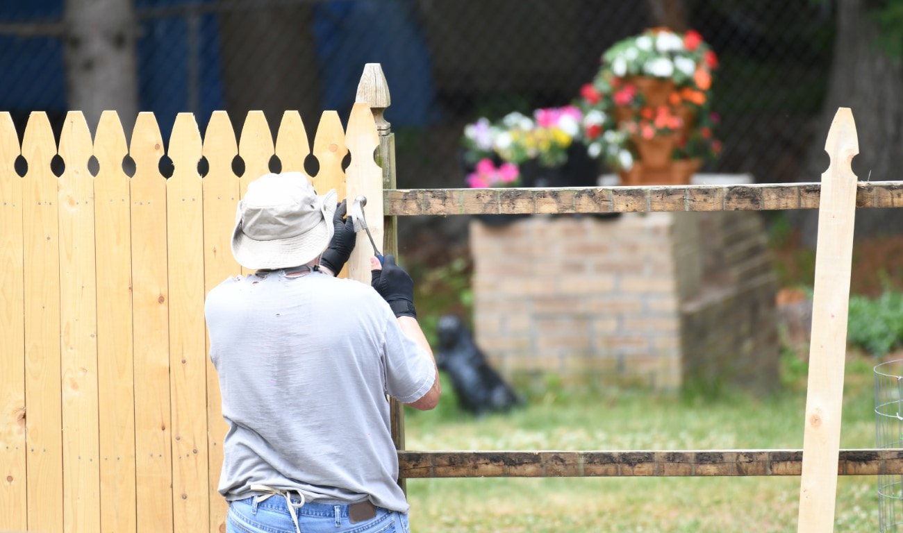 An image of a person working on a privacy fence installation service